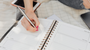 A student planning their week in a planner