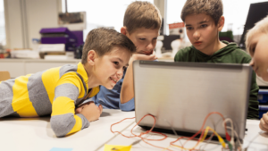 Young students looking at a laptop screen in a science lesson
