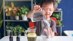 A young child doing an experiment using coloured liquids