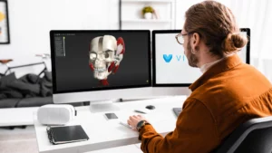 Men sitting in front of two monitors working on 3D rendering