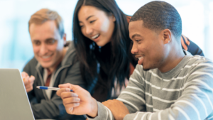 College students learning together using a laptop
