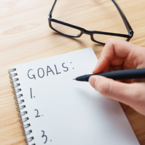 Writing goals in a notebook