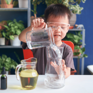 A young child doing an experiment using coloured liquids