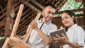Students in a carpentry lab using VIVED Learning Carpentry Course on a tablet