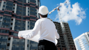Architect looking at a building and a blueprint